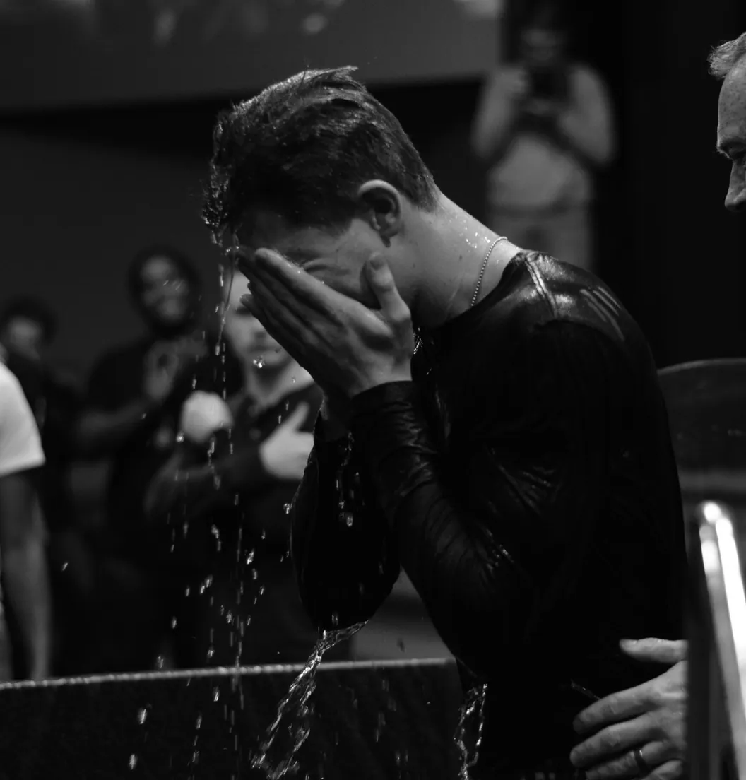 Man wiping his face after being baptized