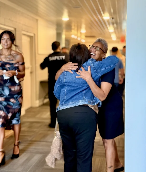 Two people hugging in the church hallway