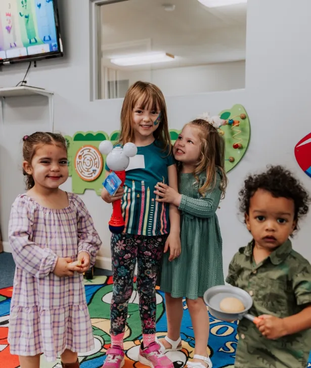 Kids smiling together in the classroom