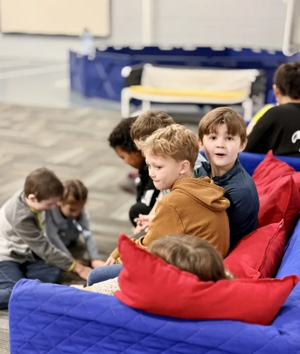 Kids relaxing on colorful cushions