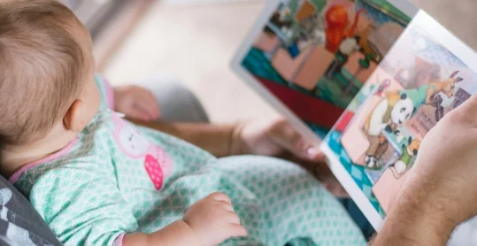 Baby looking at a picture book